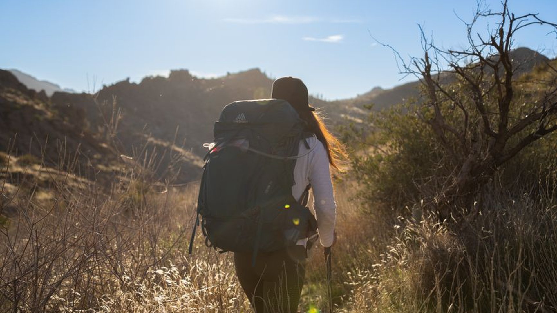 Solo hiker backpack mountain trail walking sunrise